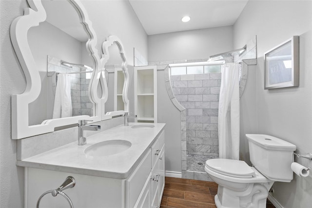 270 Hawk Ln, Brownwood, TX 76801 - bathroom featuring wood finished floors, a shower stall, toilet, double vanity, and baseboards