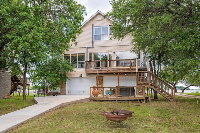 270 Hawk Ln, Brownwood, TX 76801 - rear view of house with stairs, an attached garage, and a lawn