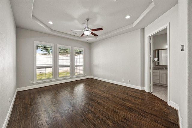 403 Conifer Ln, Allen, TX 75013 - unfurnished bedroom with a raised ceiling, dark wood-type flooring, baseboards, recessed lighting, and ensuite bath
