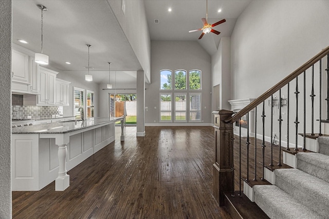 403 Conifer Ln, Allen, TX 75013 - foyer with ceiling fan, dark wood-style floors, high vaulted ceiling, stairway, and baseboards