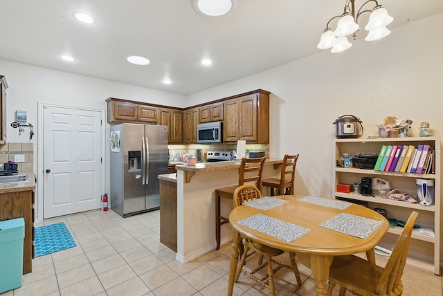 1142 Story Book Ln, Weatherford, TX 76086 - kitchen with appliances with stainless steel finishes, backsplash, light tile patterned floors, and recessed lighting
