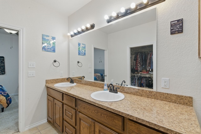 1142 Story Book Ln, Weatherford, TX 76086 - ensuite bathroom featuring double vanity, tile patterned flooring, and a spacious closet