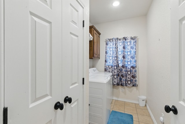 1142 Story Book Ln, Weatherford, TX 76086 - clothes washing area with light tile patterned floors, washing machine and dryer, cabinet space, and baseboards