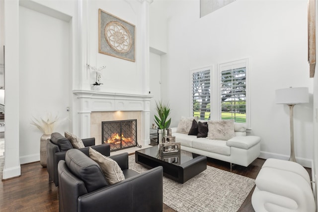 1104 Windsor Dr, Mckinney, TX 75072 - living room featuring baseboards, dark wood-style floors, a high end fireplace, and a towering ceiling