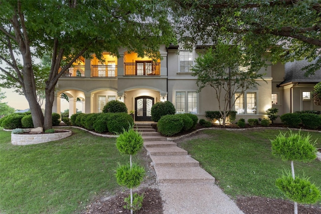 1104 Windsor Dr, Mckinney, TX 75072 - view of front facade featuring french doors, a balcony, a front lawn, and stucco siding