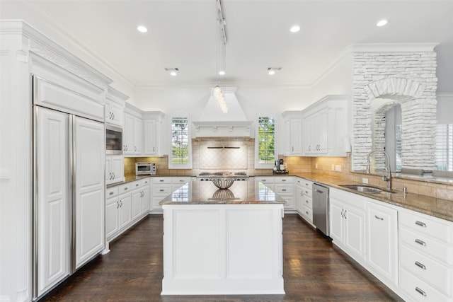 1104 Windsor Dr, Mckinney, TX 75072 - kitchen with a sink, built in appliances, stone counters, white cabinetry, and decorative backsplash