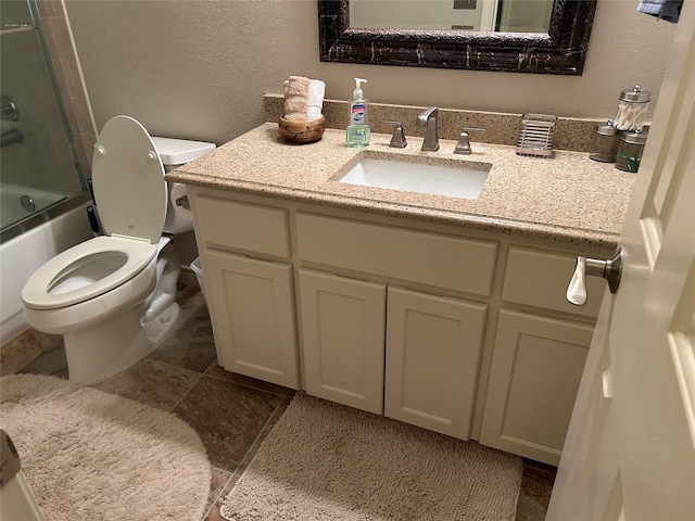 5900 Sandhill Cir, The Colony, TX 75056 - full bath with toilet, a textured wall, vanity, and bath / shower combo with glass door
