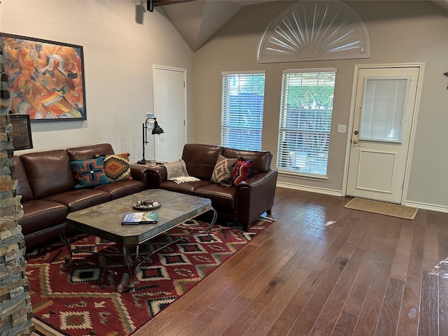 5900 Sandhill Cir, The Colony, TX 75056 - living area featuring dark wood-style floors, lofted ceiling, and baseboards