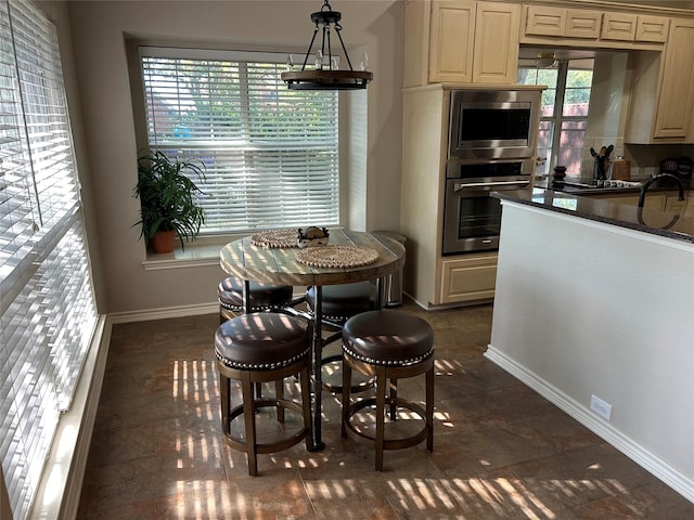 5900 Sandhill Cir, The Colony, TX 75056 - dining space featuring plenty of natural light and baseboards