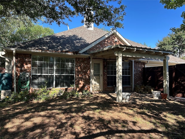 5900 Sandhill Cir, The Colony, TX 75056 - view of front facade with brick siding, roof with shingles, and a chimney