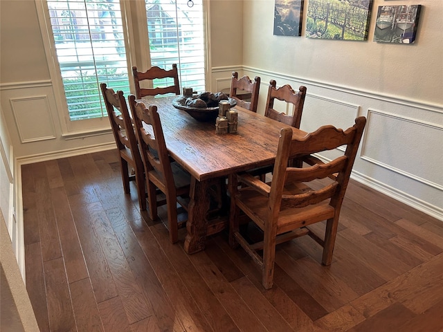 5900 Sandhill Cir, The Colony, TX 75056 - dining area with dark wood-type flooring, a decorative wall, and a wainscoted wall