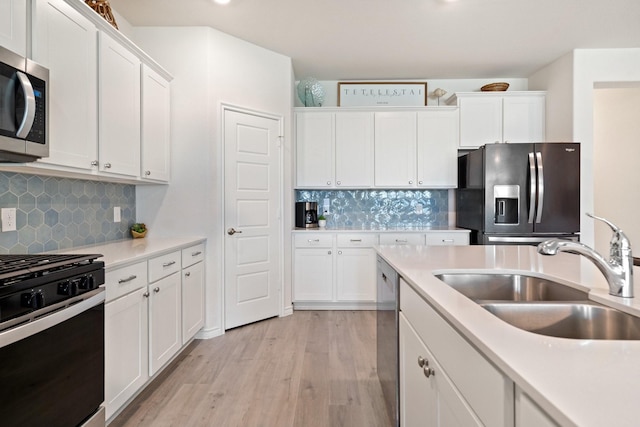3934 Faulkner Ave, Celina, TX 76227 - kitchen with stainless steel appliances, a sink, white cabinets, and light wood-style flooring