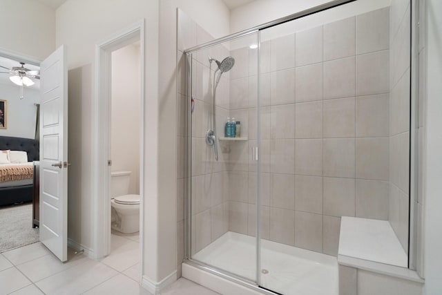 3934 Faulkner Ave, Celina, TX 76227 - bathroom with connected bathroom, a shower stall, ceiling fan, toilet, and tile patterned flooring