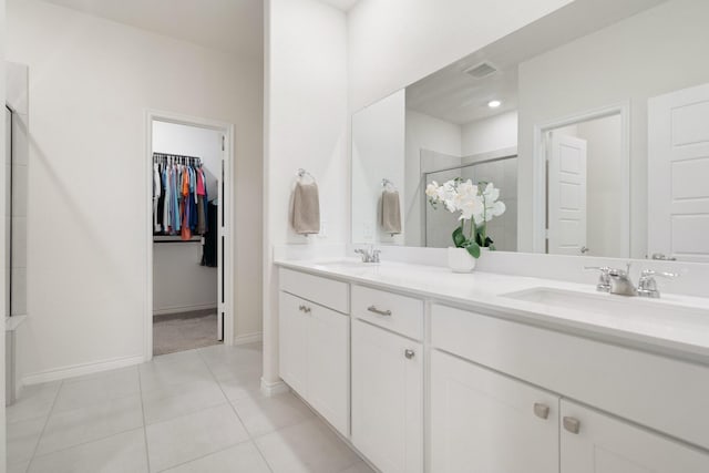3934 Faulkner Ave, Celina, TX 76227 - full bath with a shower stall, double vanity, tile patterned floors, a walk in closet, and baseboards
