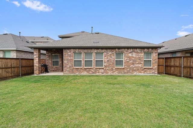 3934 Faulkner Ave, Celina, TX 76227 - rear view of house with roof with shingles, brick siding, and a patio