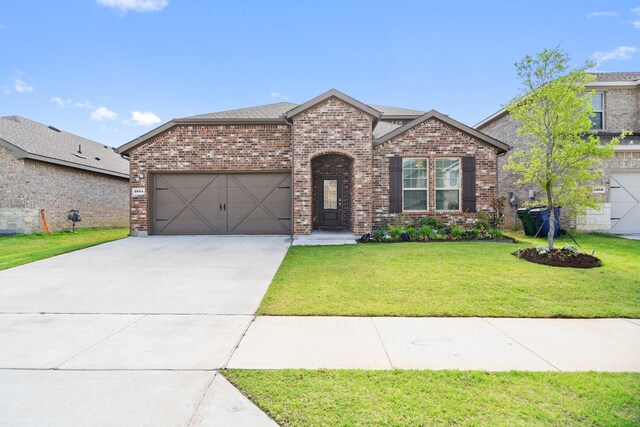 3934 Faulkner Ave, Celina, TX 76227 - view of front of house with brick siding, a garage, driveway, and a front yard