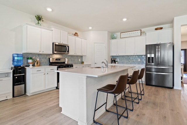 3934 Faulkner Ave, Celina, TX 76227 - kitchen with appliances with stainless steel finishes, a sink, light wood finished floors, light countertops, and white cabinets