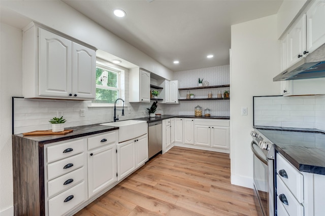 2810 Sunny Hill Ln, Farmers Branch, TX 75234 - kitchen featuring stainless steel appliances, open shelves, dark countertops, light wood finished floors, and recessed lighting