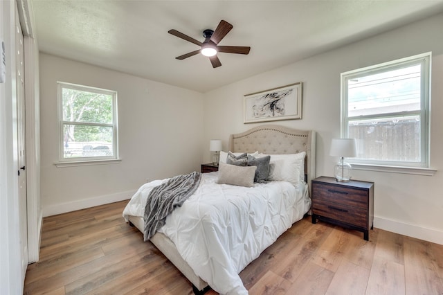 2810 Sunny Hill Ln, Farmers Branch, TX 75234 - bedroom with light wood-style flooring and a ceiling fan