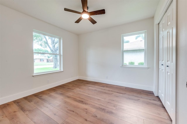2810 Sunny Hill Ln, Farmers Branch, TX 75234 - unfurnished bedroom with multiple windows, a closet, and light wood-style flooring