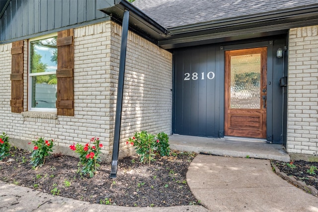 2810 Sunny Hill Ln, Farmers Branch, TX 75234 - property entrance with a shingled roof and brick siding