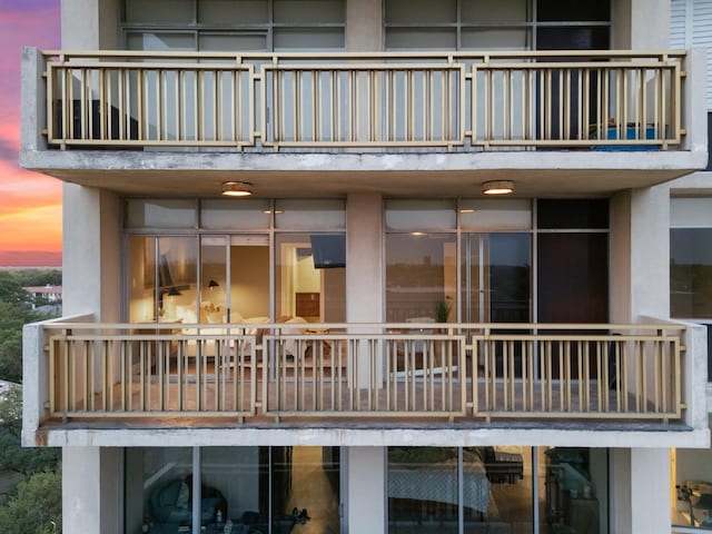6211 W NW Unit 701, Dallas, TX 75225 - rear view of house with a balcony and stucco siding