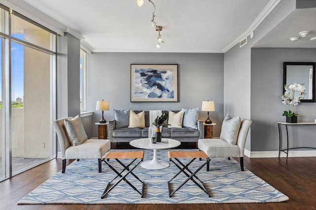 6211 W NW Unit 701, Dallas, TX 75225 - living area with wood finished floors, baseboards, and ornamental molding
