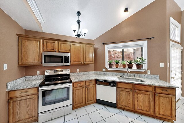 208 Lydia Cir, Irving, TX 75060 - kitchen with appliances with stainless steel finishes, a sink, lofted ceiling, brown cabinets, and light tile patterned floors