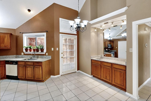208 Lydia Cir, Irving, TX 75060 - kitchen featuring a sink, brown cabinetry, stainless steel appliances, a chandelier, and baseboards