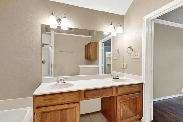 208 Lydia Cir, Irving, TX 75060 - bathroom with a shower with shower door, double vanity, and a bathtub