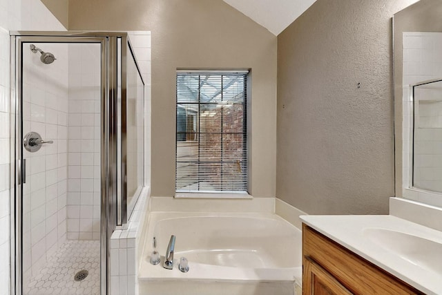208 Lydia Cir, Irving, TX 75060 - full bath featuring a textured wall, a stall shower, a garden tub, vanity, and vaulted ceiling