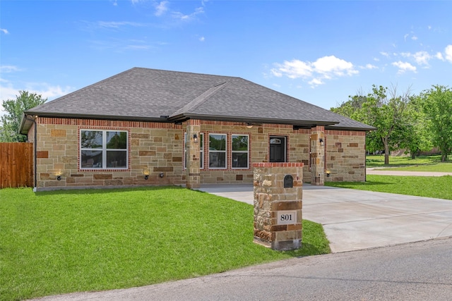 view of front of house with a shingled roof, stone siding, and driveway