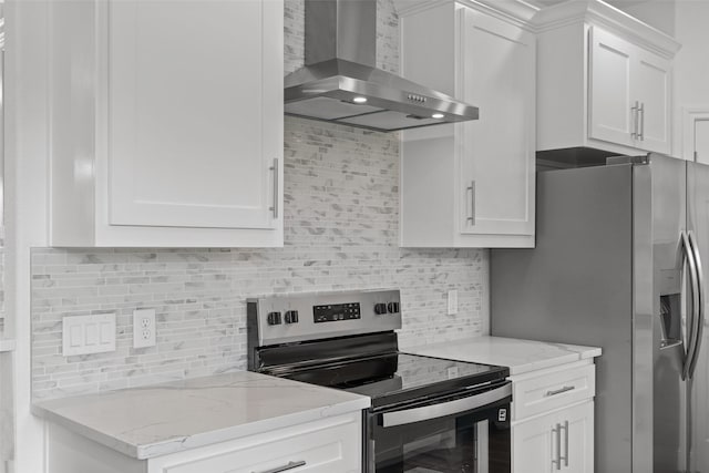 kitchen featuring stainless steel appliances, wall chimney exhaust hood, backsplash, and white cabinets