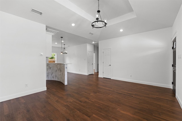 unfurnished living room featuring a chandelier, dark wood-style flooring, baseboards, and recessed lighting