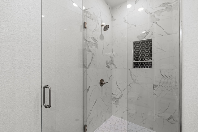 full bath with a marble finish shower