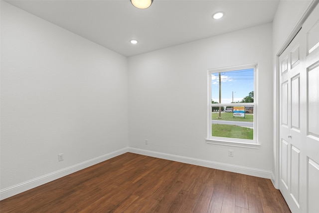 unfurnished room with baseboards, dark wood-style floors, and recessed lighting