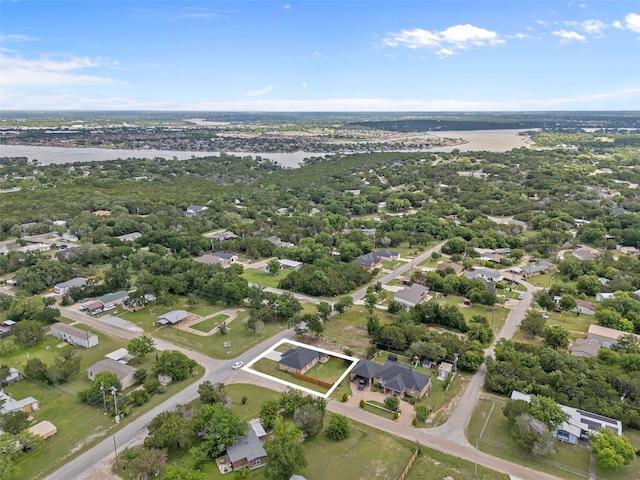 aerial overview of property's location with a large body of water, property parcel outlined, and nearby suburban area
