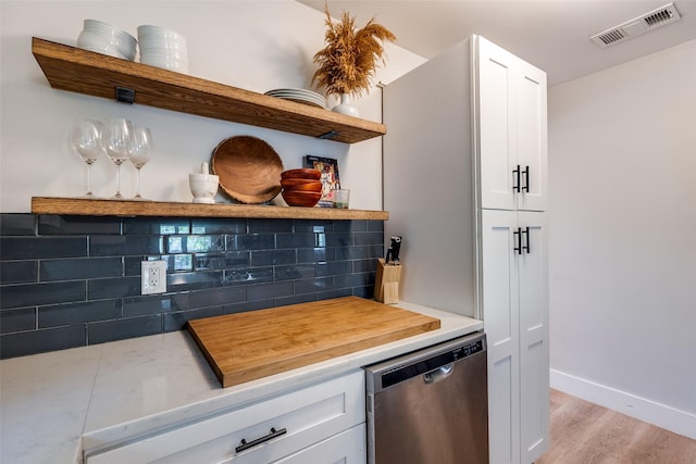 922 S Waverly Dr, Dallas, TX 75208 - kitchen with open shelves, dishwasher, tasteful backsplash, and white cabinets