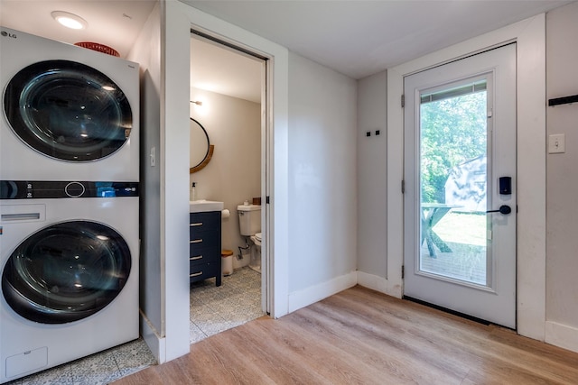 922 S Waverly Dr, Dallas, TX 75208 - laundry area with stacked washer and clothes dryer and light wood-style flooring