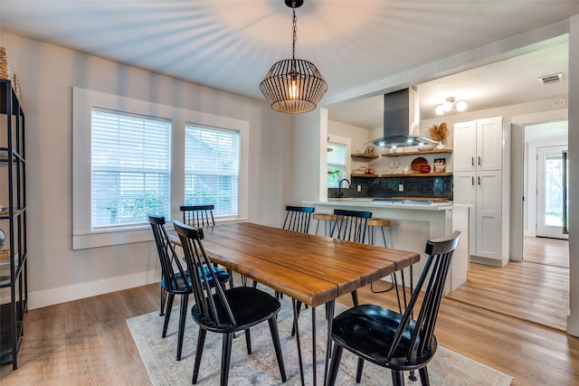 922 S Waverly Dr, Dallas, TX 75208 - dining room featuring healthy amount of natural light, light wood finished floors, and baseboards