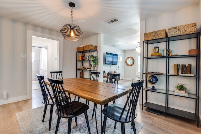 922 S Waverly Dr, Dallas, TX 75208 - dining room with light wood-type flooring, baseboards, and healthy amount of natural light