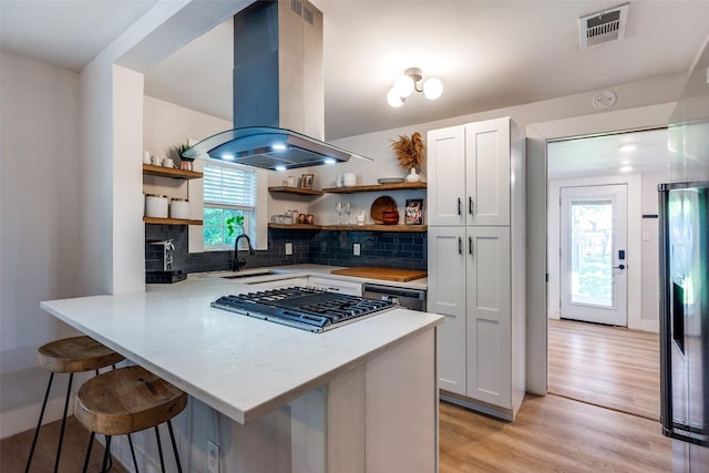 922 S Waverly Dr, Dallas, TX 75208 - kitchen featuring open shelves, island range hood, a sink, and gas cooktop