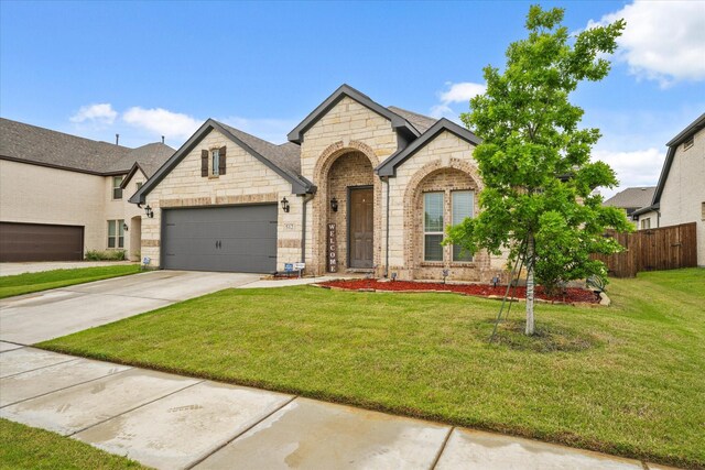 512 Navo Rd, Little Elm, TX 75068 - french country inspired facade with stone siding, an attached garage, driveway, and brick siding