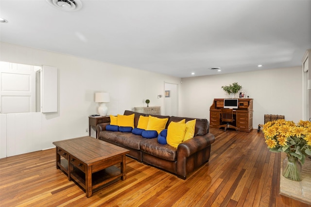 living room with wood-type flooring and recessed lighting