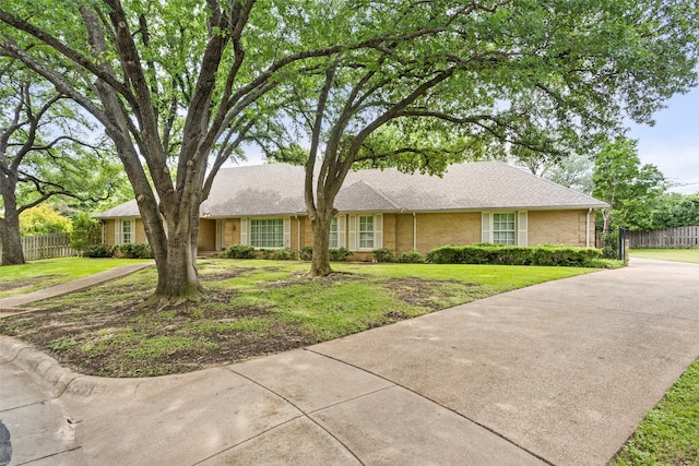 ranch-style house with driveway and brick siding