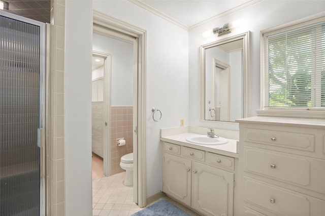 bathroom featuring tile patterned flooring, toilet, a stall shower, tile walls, and vanity