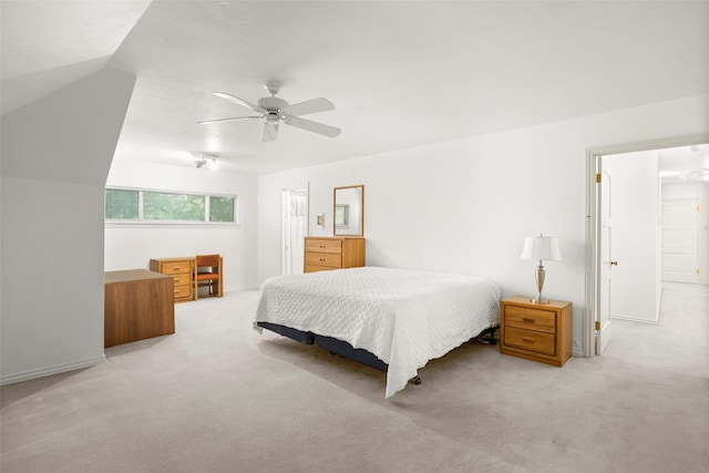 bedroom featuring light carpet, baseboards, and ceiling fan