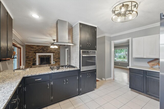 4816 Reynolds Rd, North Richland Hills, TX 76180 - kitchen with stainless steel appliances, exhaust hood, light tile patterned flooring, ornamental molding, and ceiling fan