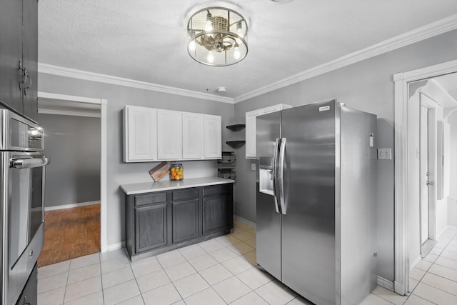 4816 Reynolds Rd, North Richland Hills, TX 76180 - kitchen with stainless steel appliances, white cabinetry, light countertops, ornamental molding, and light tile patterned floors