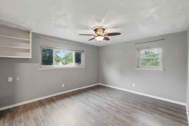 4816 Reynolds Rd, North Richland Hills, TX 76180 - empty room with healthy amount of natural light, wood finished floors, ceiling fan, and baseboards